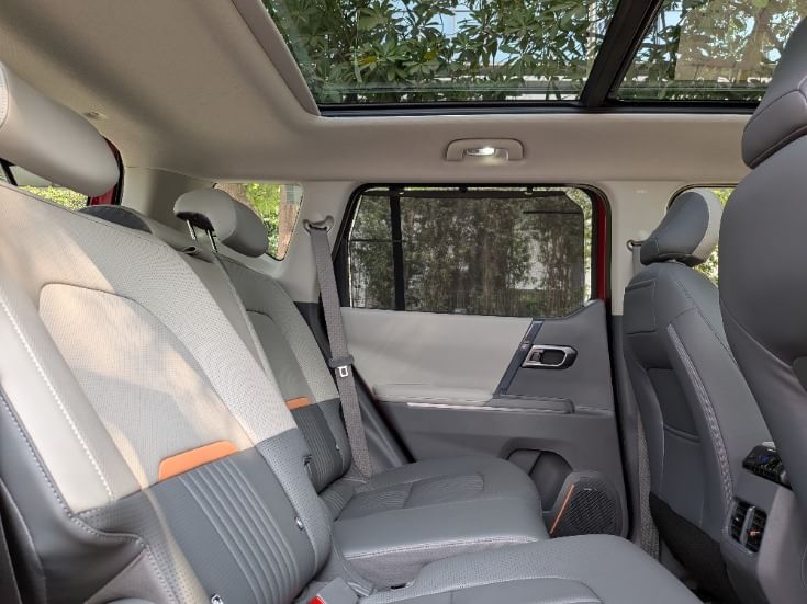 Segment-first sliding and reclining rear seats significantly enhance practicality inside the Syros' cabin. Ambient lighting and a panoramic sunroof further augment cabin ambience.