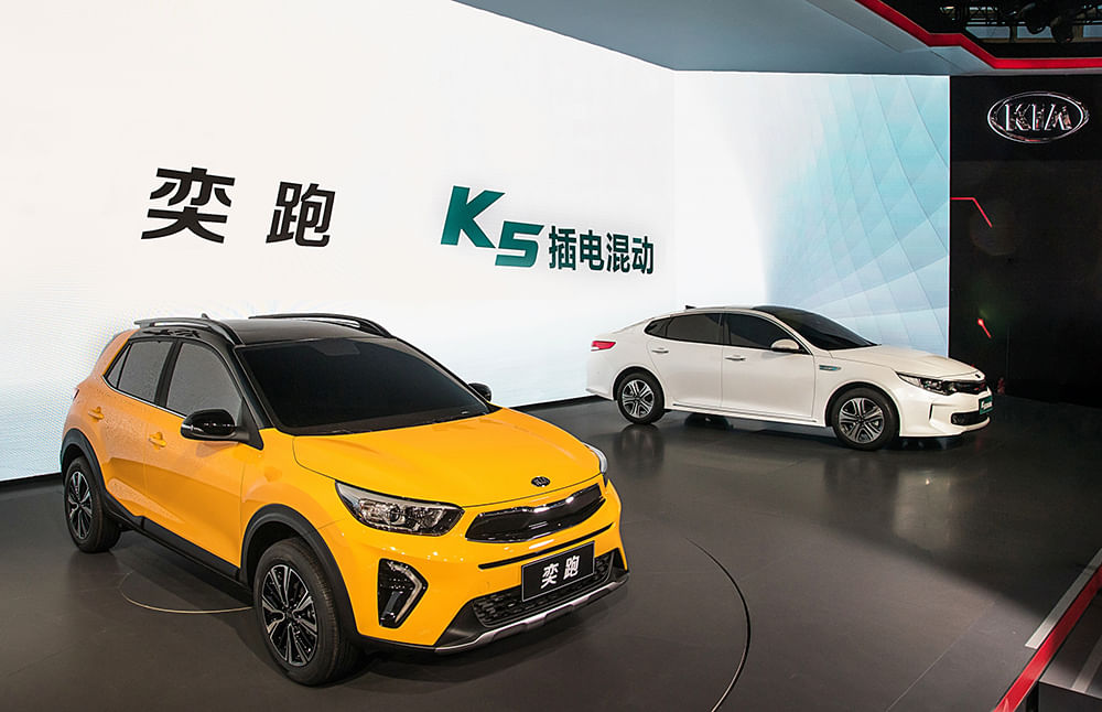 Kia unveils its latest urban SUV and a hybrid version of the Optima in Beijing